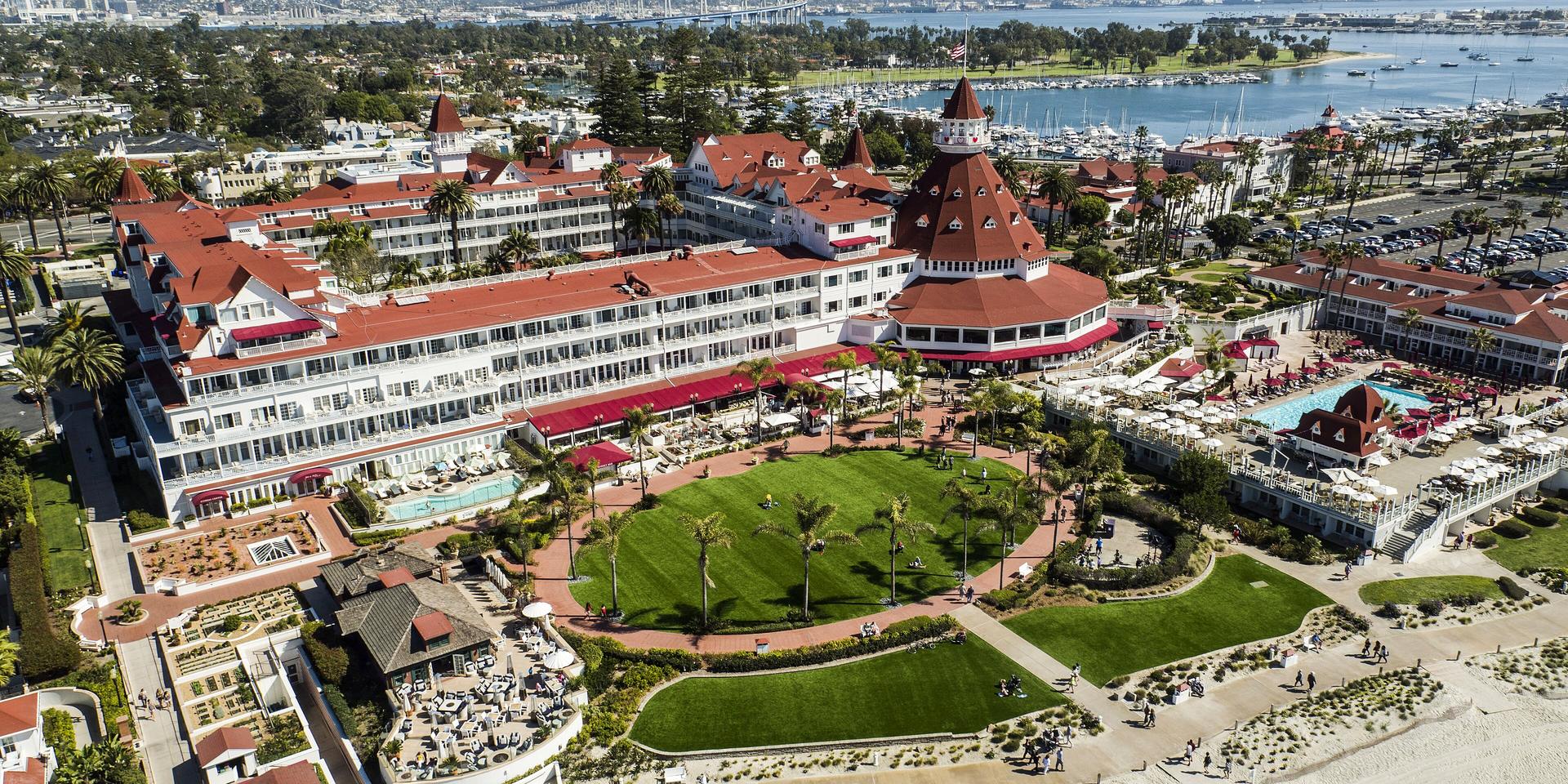 Aerial view of the Hotel del Coronado with the bay and bridge behind