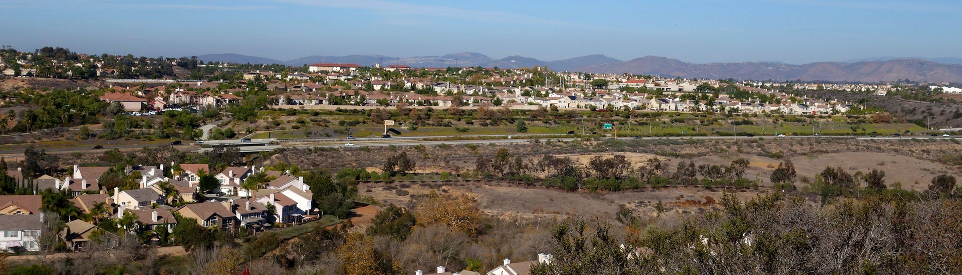 Panoramic view across Carmel Valley with planned communities and the inland mountains